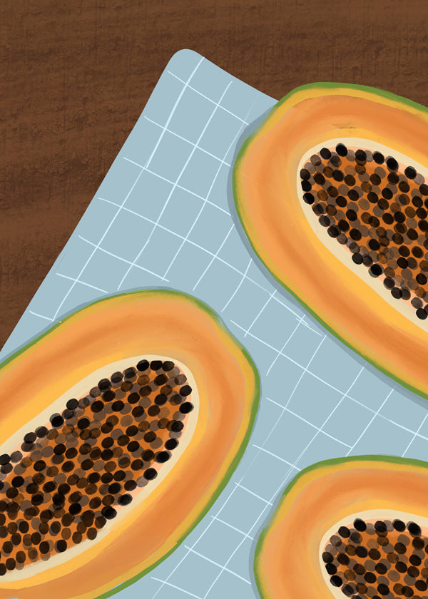 Køkkenkunst: halve papaya på ternet stof