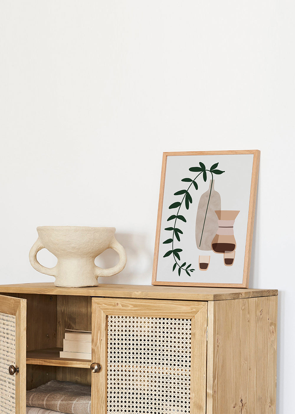 Køkkenkunst med kaffekande og botanisk gren