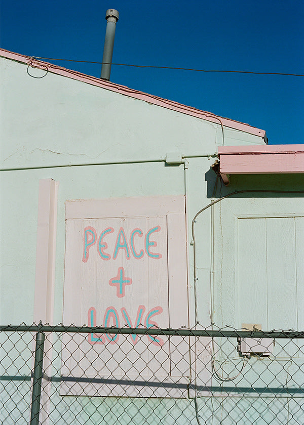 Fotografi af facade med Peace + Love-graffiti