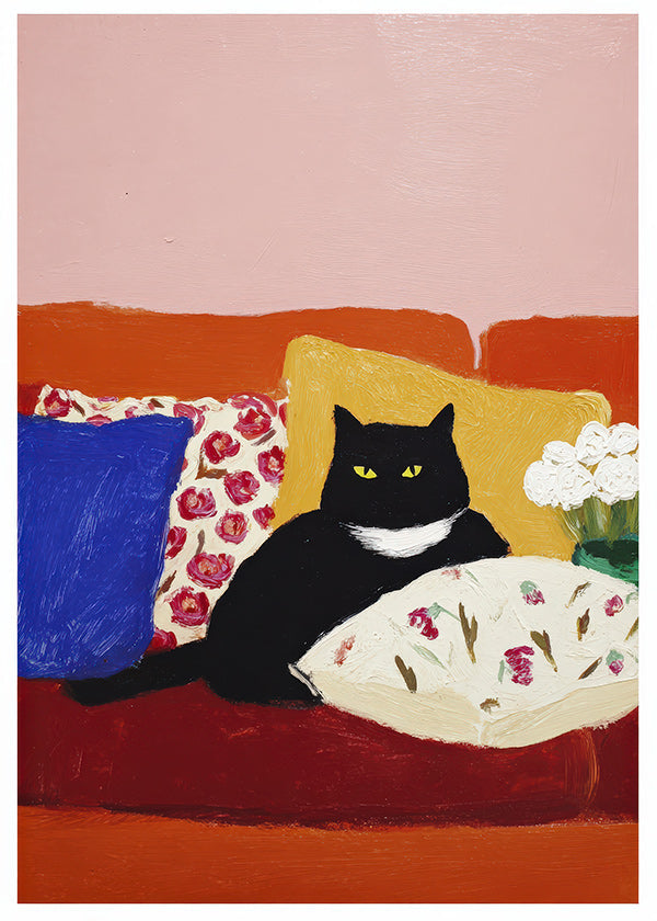 Kunst sort kat på farverig sofa