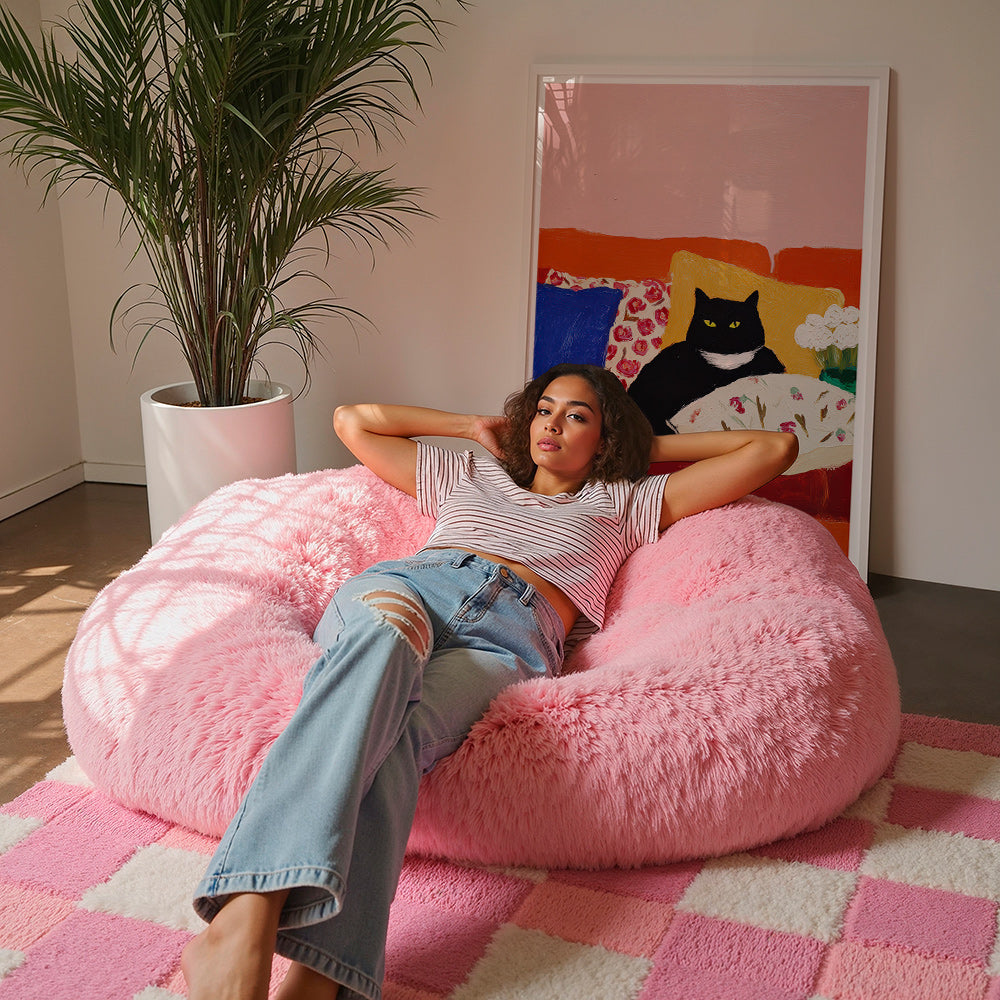 Kunst sort kat på farverig sofa