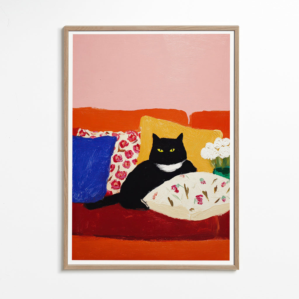 Kunst sort kat på farverig sofa